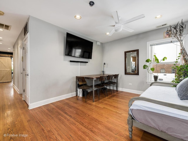 bedroom with ceiling fan and light wood-type flooring