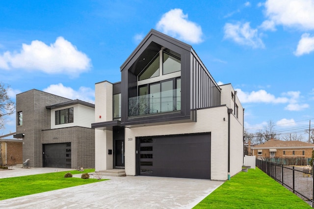 modern home with brick siding, fence, driveway, and an attached garage