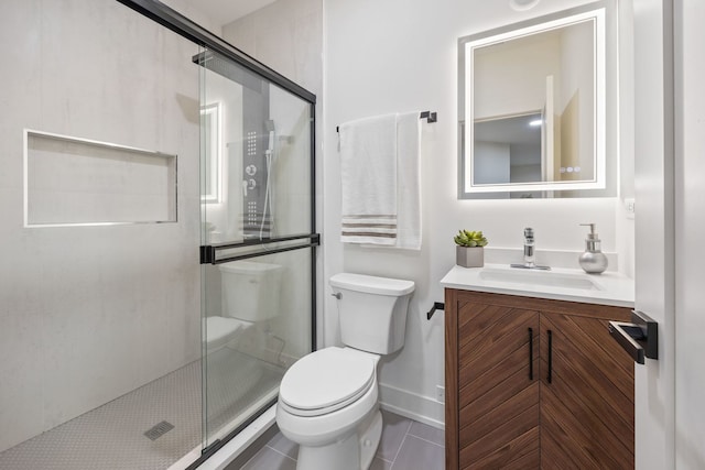 bathroom featuring baseboards, toilet, tile patterned floors, vanity, and a shower stall