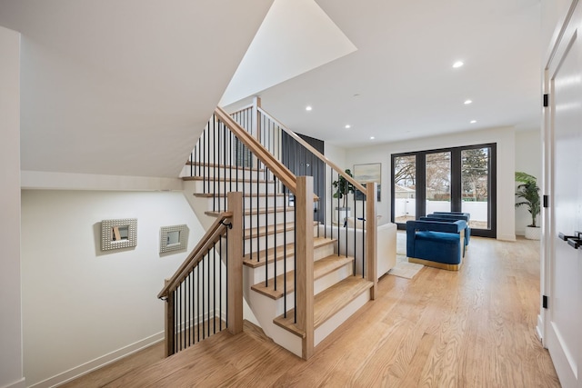 stairs featuring recessed lighting, french doors, baseboards, and wood finished floors