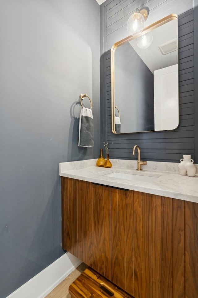 bathroom featuring vanity and baseboards