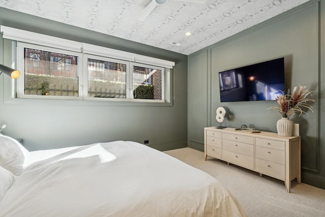 bedroom with light carpet and multiple windows