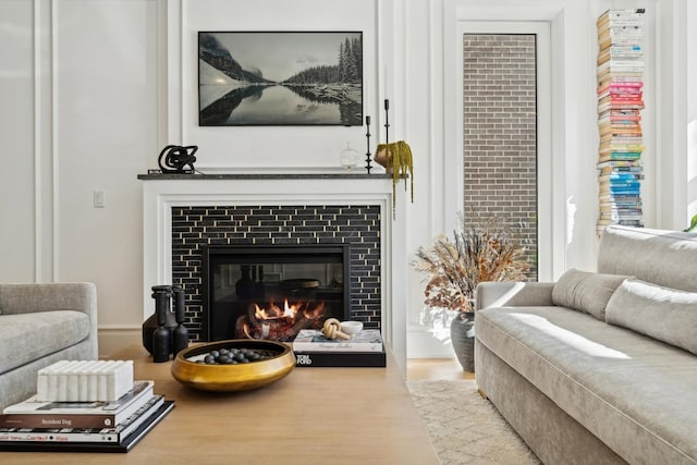 living area featuring light wood-type flooring and a fireplace