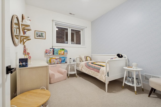 carpeted bedroom featuring visible vents