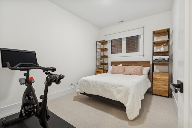 carpeted bedroom featuring visible vents and baseboards