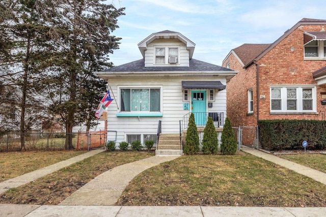 bungalow-style home featuring a front yard