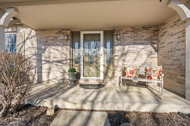 view of exterior entry with brick siding