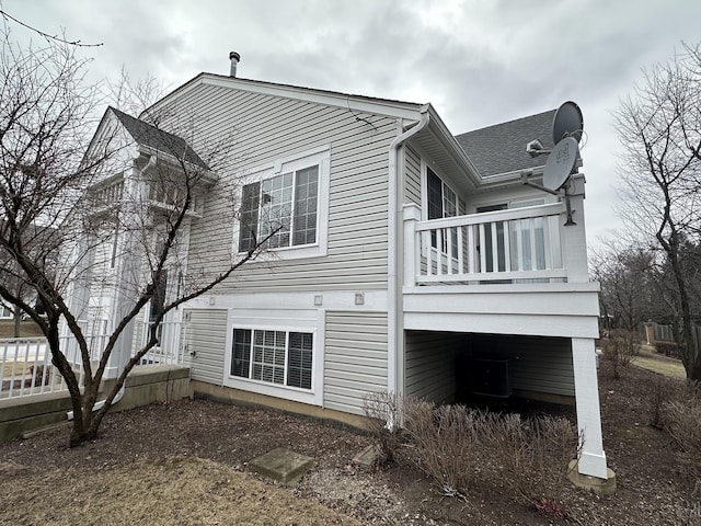 rear view of house with a balcony and central AC