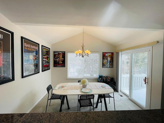 dining room featuring vaulted ceiling, carpet flooring, an inviting chandelier, and breakfast area