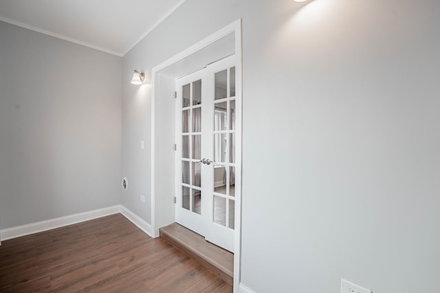 spare room with crown molding, dark hardwood / wood-style flooring, and french doors