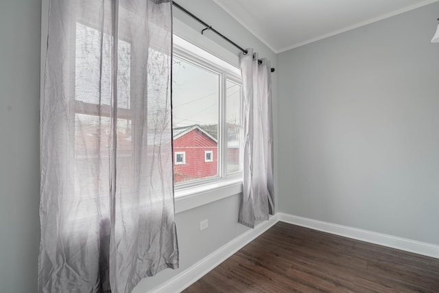 empty room featuring crown molding and dark hardwood / wood-style floors