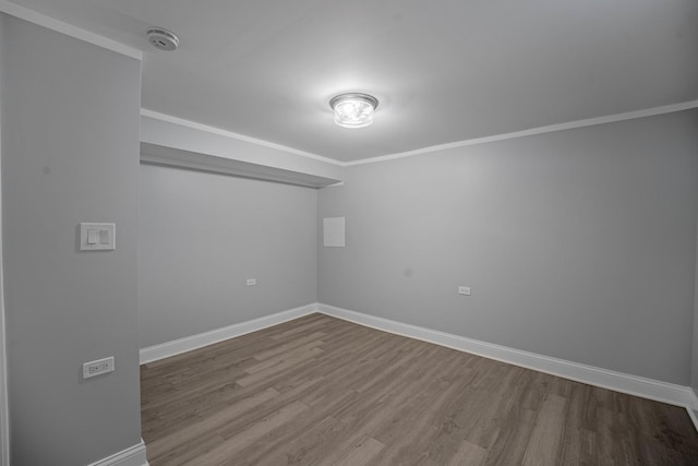 unfurnished room with hardwood / wood-style floors and ornamental molding