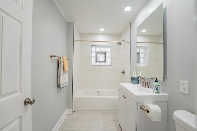 full bathroom with vanity, tiled shower / bath combo, and toilet