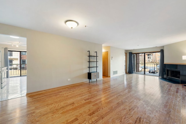 unfurnished living room featuring light wood-type flooring