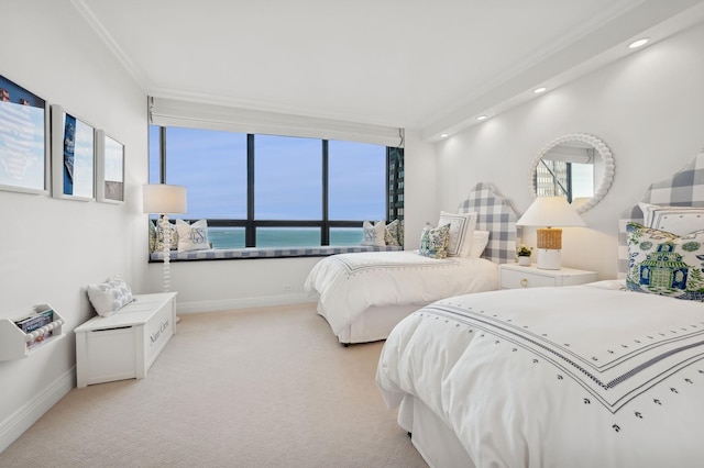 bedroom featuring ornamental molding, light carpet, and a water view