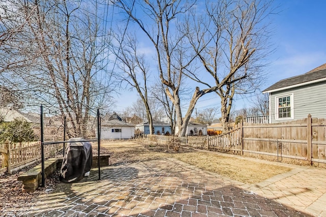 view of yard featuring fence private yard, a patio, and an outdoor structure