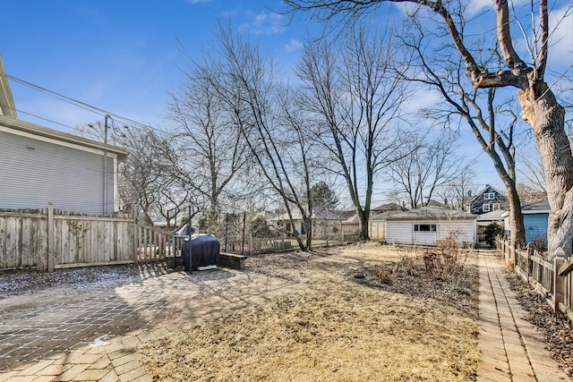 view of yard with a fenced backyard and an outdoor structure