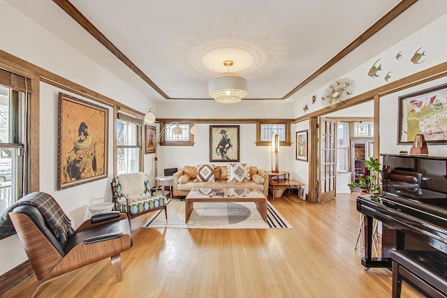 living room featuring light wood-style floors and a notable chandelier