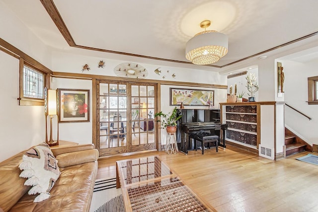 interior space with hardwood / wood-style flooring, visible vents, stairway, and french doors