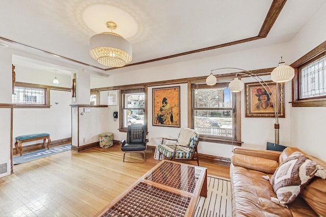 living area featuring visible vents, baseboards, and wood finished floors