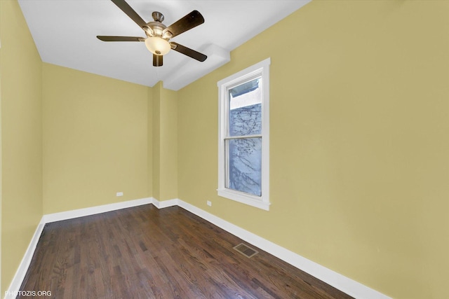 unfurnished room featuring ceiling fan, dark wood-type flooring, visible vents, and baseboards