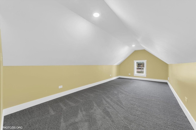 bonus room with lofted ceiling, dark carpet, baseboards, and recessed lighting