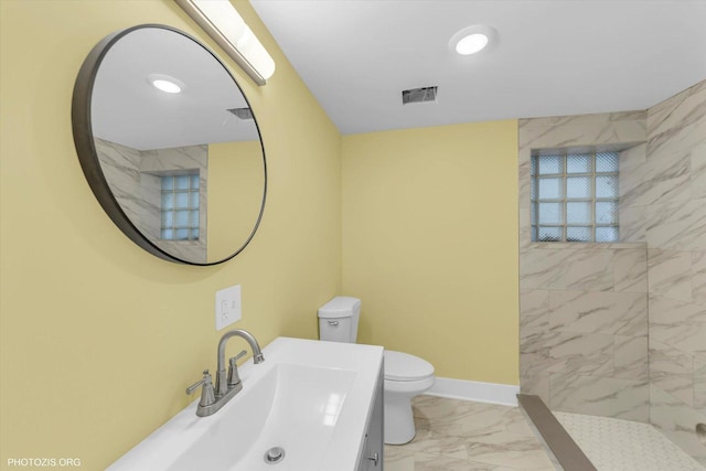 bathroom with baseboards, visible vents, toilet, marble finish floor, and vanity