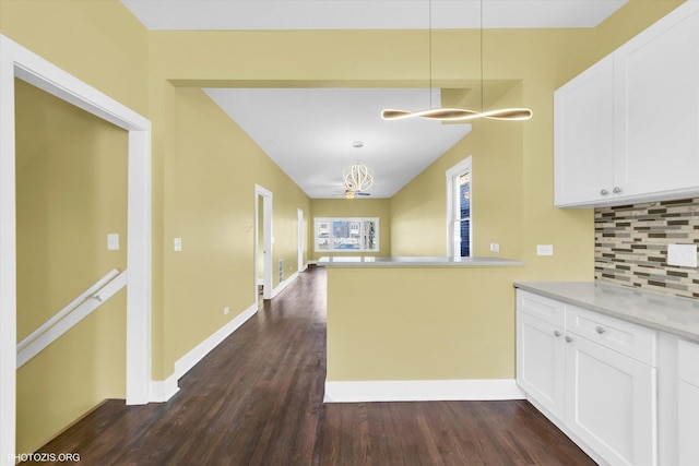 kitchen featuring tasteful backsplash, baseboards, white cabinets, and dark wood-style flooring