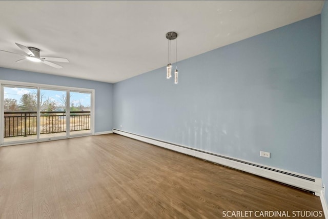 spare room with ceiling fan, a baseboard radiator, and wood-type flooring