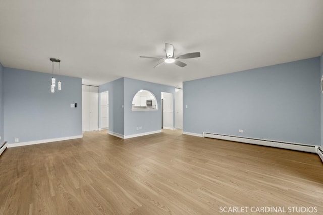 unfurnished living room with a baseboard heating unit, ceiling fan, and light hardwood / wood-style floors