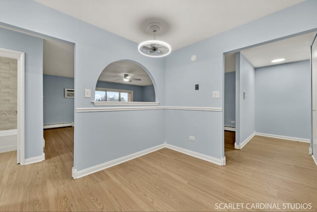 interior space featuring light wood-type flooring and baseboard heating