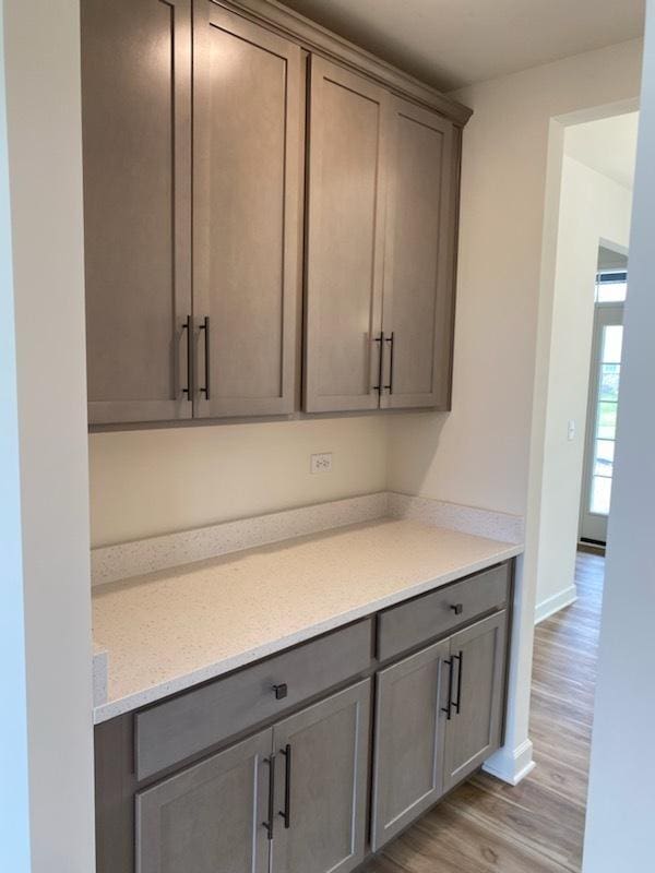 interior space with baseboards and light wood-style flooring