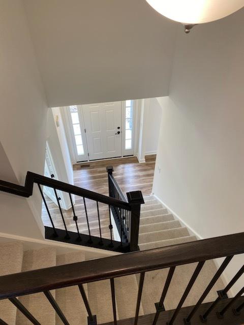stairway featuring baseboards and wood finished floors