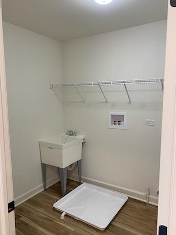 washroom featuring baseboards, wood finished floors, laundry area, and washer hookup