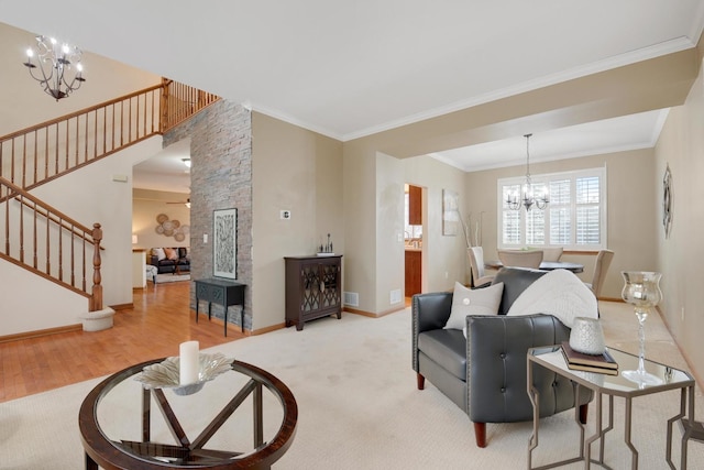 living room with crown molding, a chandelier, and light hardwood / wood-style floors