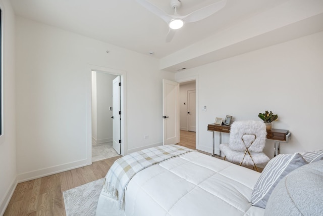 bedroom featuring wood finished floors, a ceiling fan, and baseboards