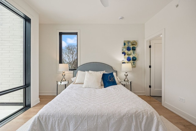 bedroom featuring light wood-style flooring and baseboards