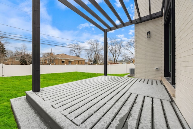 wooden deck with a fenced backyard and a lawn