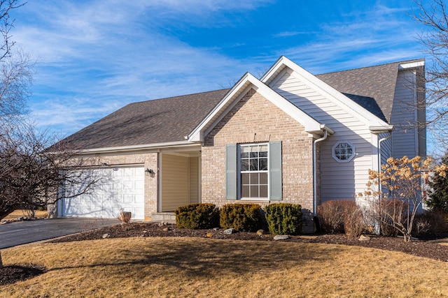 view of front of house with a front yard and a garage