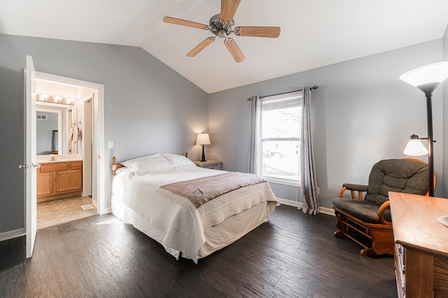 bedroom with connected bathroom, ceiling fan, vaulted ceiling, and dark hardwood / wood-style flooring