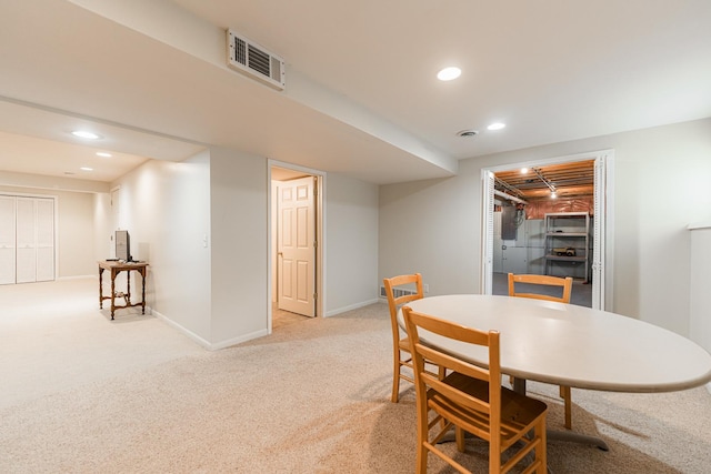 dining area with light colored carpet