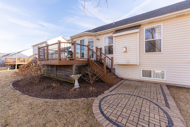 back of property featuring a patio area and a deck