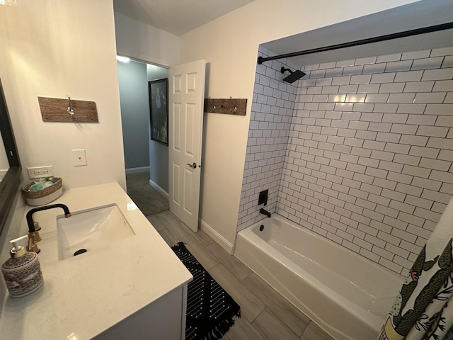 bathroom featuring vanity and tiled shower / bath combo