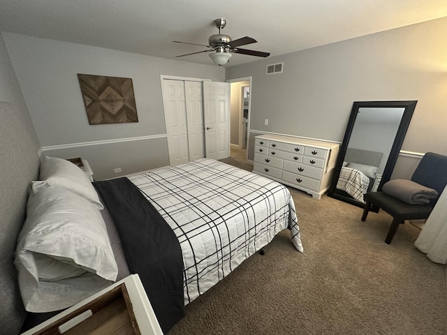 carpeted bedroom featuring ceiling fan and a closet