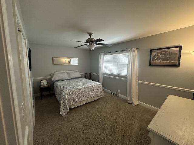 bedroom featuring ceiling fan and dark colored carpet