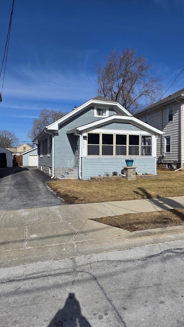 view of front of home with a garage and an outdoor structure