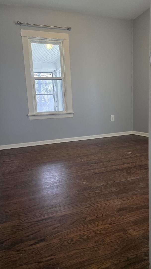 spare room featuring dark hardwood / wood-style floors