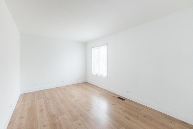 spare room with light wood-type flooring