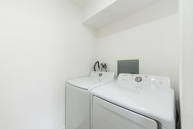 clothes washing area with separate washer and dryer