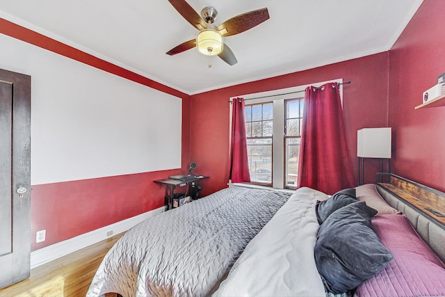 bedroom featuring light hardwood / wood-style flooring, ornamental molding, and ceiling fan